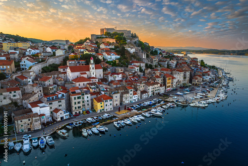 Sibenik, Croatia - Aerial panoramic view of the mediterranean old town of Sibenik on a sunny summer morning with Saint James Cathedral, Fortress of Saint Michael and dramatic golden sunrise  photo