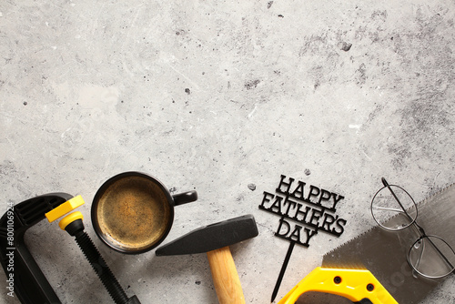 Flatlay composition with carpenters tools and coffee mug on stone background. Happy Father's Day concept. Top view.