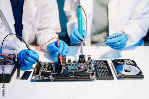The technician is putting the CPU on the socket of the computer motherboard. electronic engineering electronic repair, electronics measuring