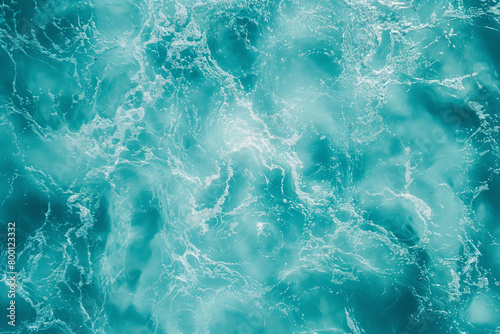 Aerial view of a turquoise water surface texture in a flat lay shot from a top down perspective in a close up