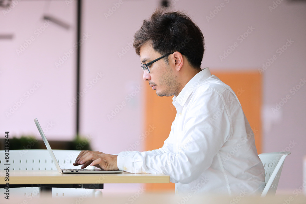 Young business man in glasses with laptop computer working office or online shopping, home work, freelance, online learning, studying. Young business man in glasses with laptop computer working office or online shopping, home work, freelance, online learning, studying.