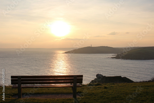 bench at sunset with view of the cornish coastline