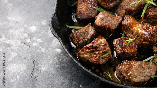 Garlic butter beef steak bites in iron cast pan