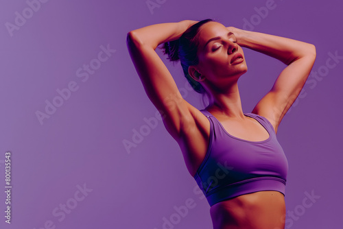 A fitness model demonstrating a Pilates move, focused and serene, against a calm wellness purple background
