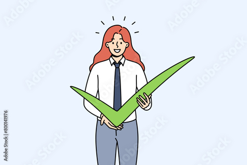 Business woman shows check mark as sign of confirmation of plans for cooperation or completion of project. Successful businesswoman with green check mark casts vote for favorite political candidate