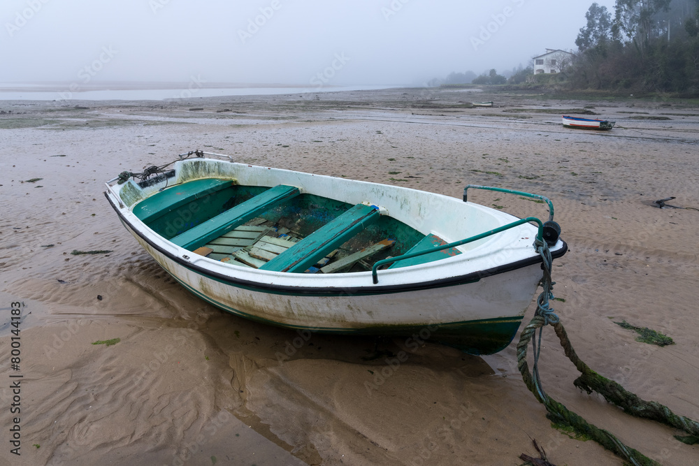 Fishing boats in the Villaviciosa estuary in a foggy day. Asturias, Spain.