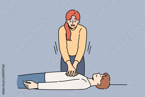 Woman nervous, giving heart massage to man fainted, pressing on chest muscles. Training in first aid and rescue of person with sudden heart failure or impaired cardio functions of body