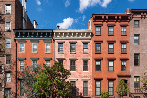 Row of townhouses with red brick facades in Chelsea Historic District. Manhattan, New York City