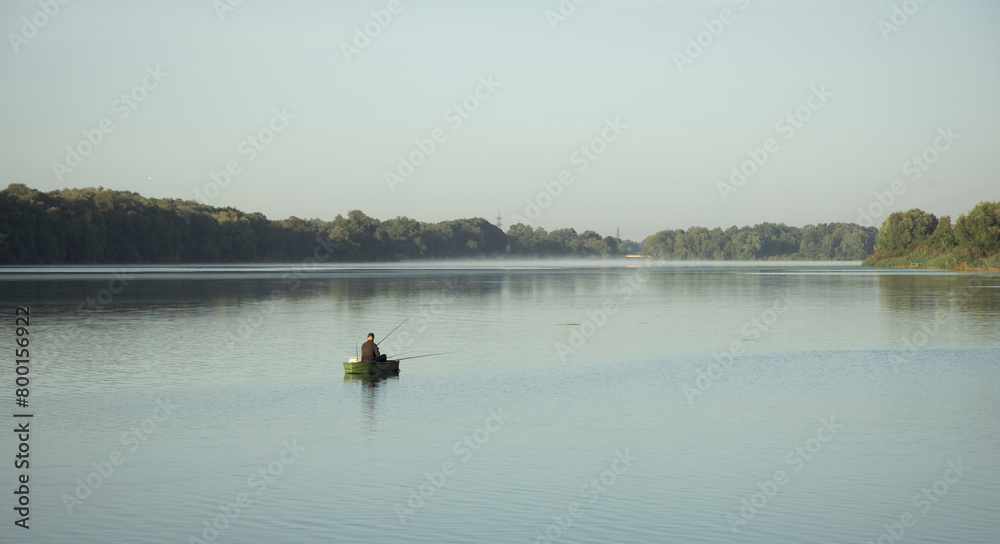 fishing activity one man in the boat back to camera on river morning time picture