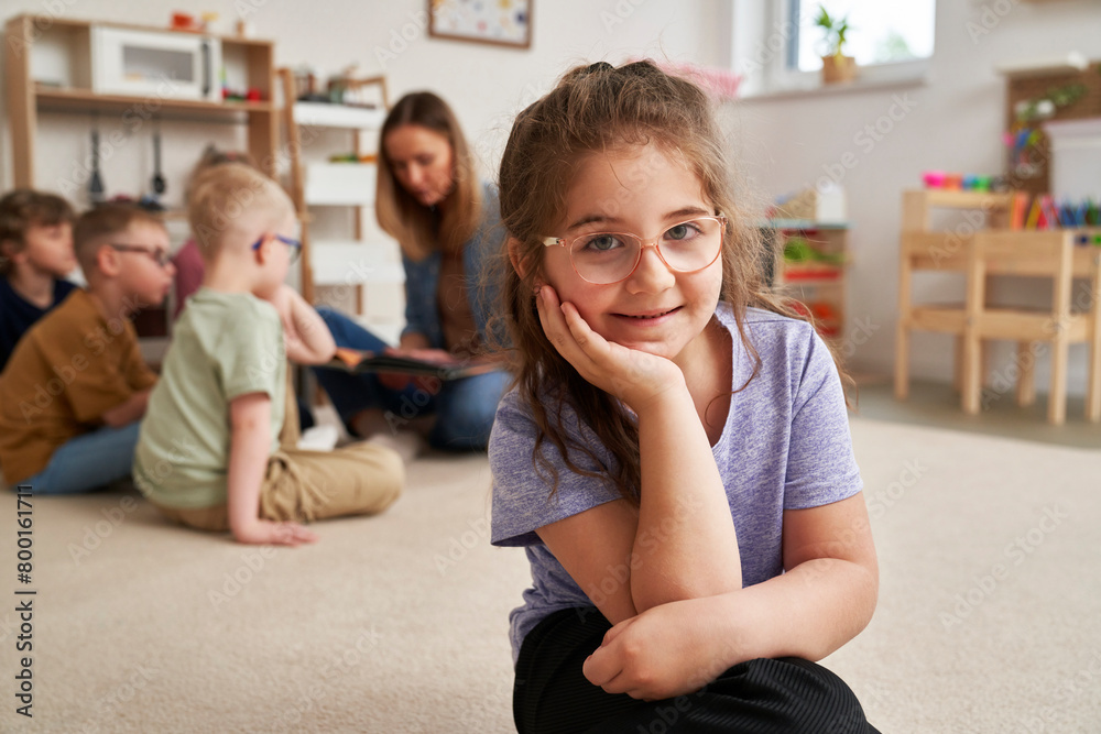 Portrait of preschool girl and children in the background Portrait of preschool girl and children in the background