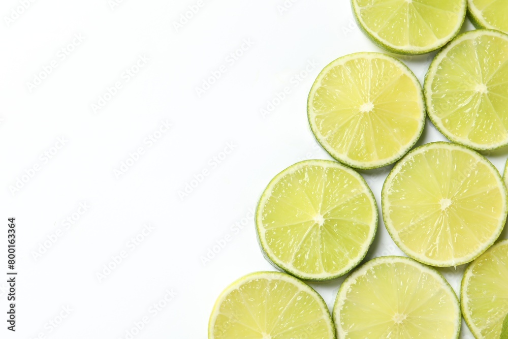 Fresh juicy lime slices on white background, flat lay. Space for text Fresh juicy lime slices on white background, flat lay. Space for text
