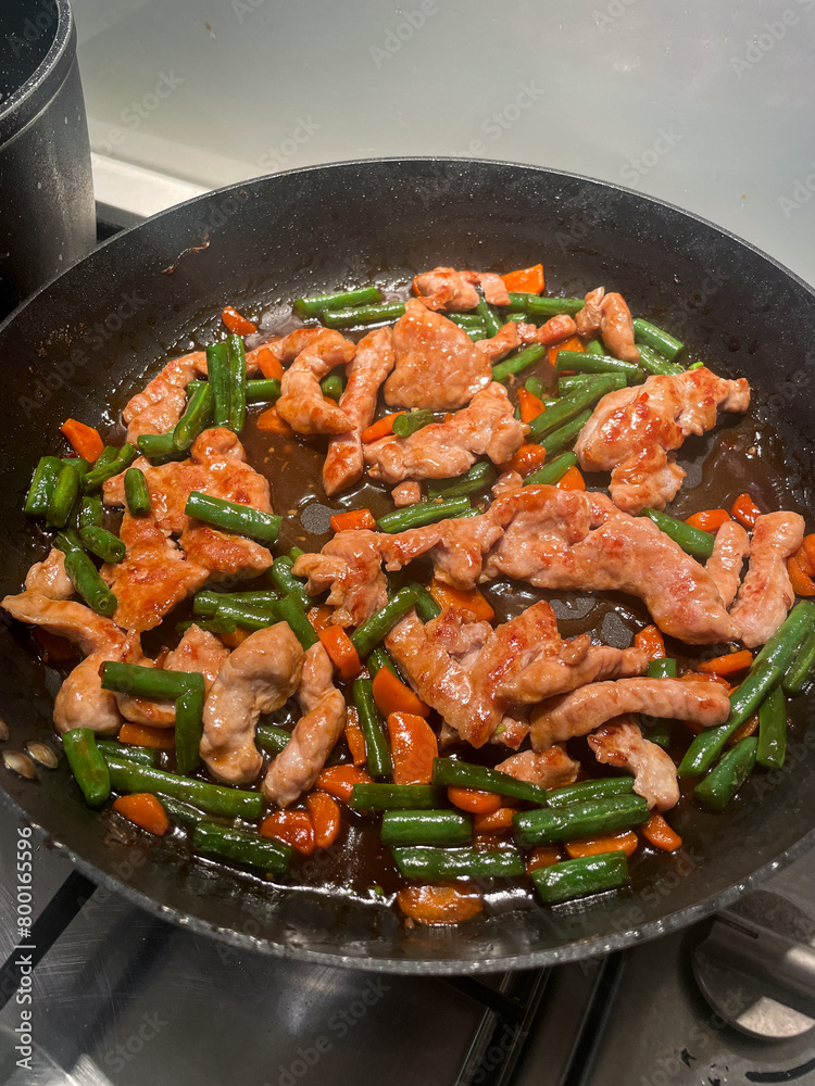 Pork and vegetable stir fry in the pan.