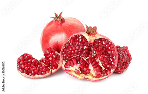 Cut and whole pomegranates isolated on white