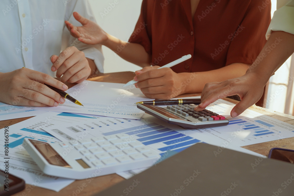 A group of professional businesswomen engaged in a collaborative meeting in a modern office setting. Concentrated and smiling, they discuss ideas and plans for successful teamwork A group of professional businesswomen engaged in a collaborative meeting in a modern office setting. Concentrated and smiling, they discuss ideas and plans for successful teamwork