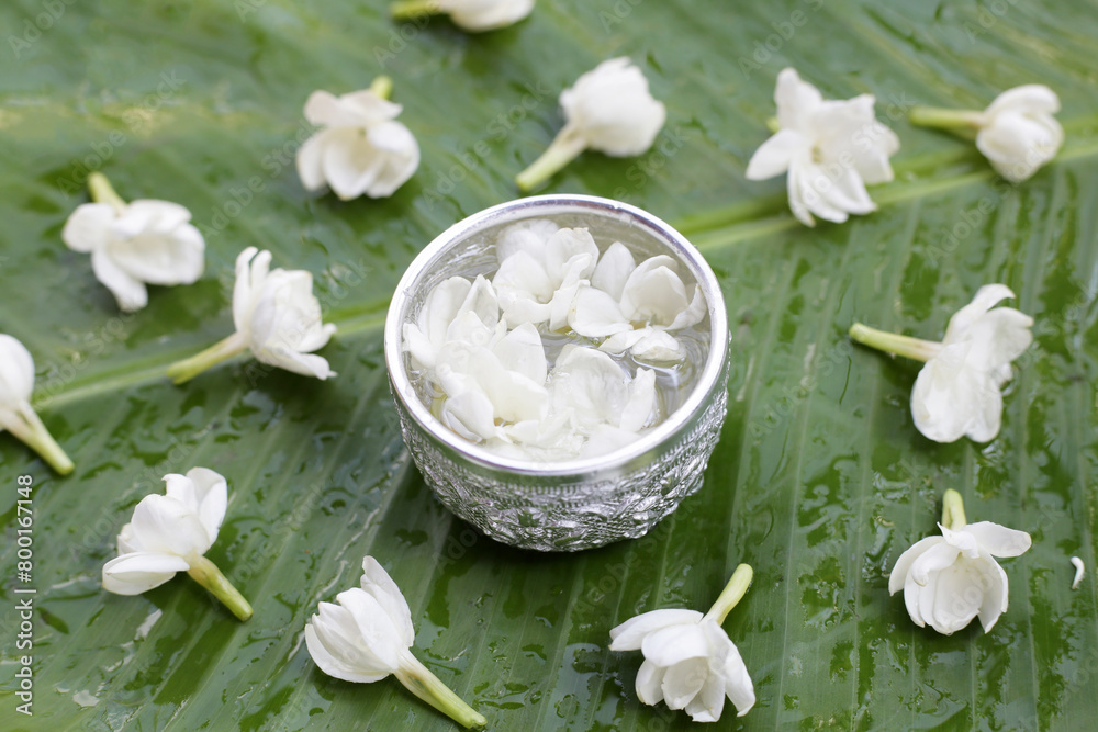 Water with jasmine flower with rose. Thai tradition, Songkran festival concept Water with jasmine flower with rose. Thai tradition, Songkran festival concept