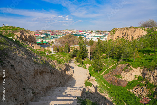 Stairway on the side of the Afrosiyab Hill on the grounds of the Khoja Doniyor (Saint Daniel) Mausoleum in Samarkand, Uzbekistan - Grassy hill that was the site of a Sogdian city photo