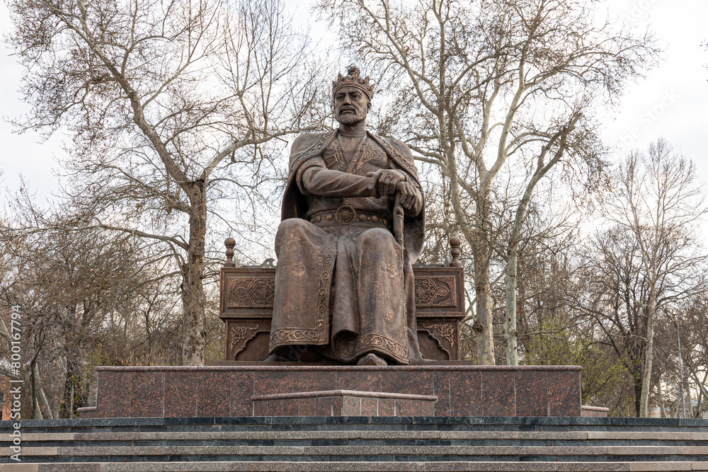 Amir Temur Monument in Samarkand, Uzbekistan, Central Asia - Bronze statue of the famous conqueror who founded the Timurid Empire seated on his throne Amir Temur Monument in Samarkand, Uzbekistan, Central Asia - Bronze statue of the famous conqueror who founded the Timurid Empire seated on his throne
