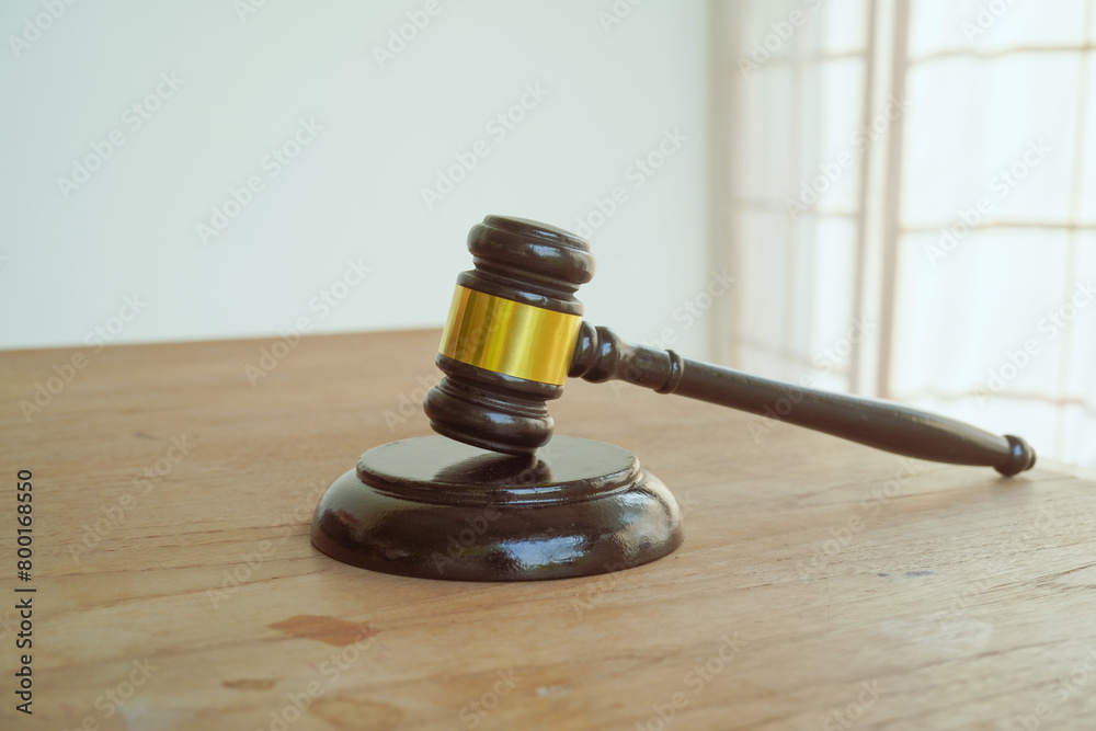 A symbolic image of a wooden gavel, representing law and judgment. With a white background, it evokes the concepts of justice, authority, and legal proceedings A symbolic image of a wooden gavel, representing law and judgment. With a white background, it evokes the concepts of justice, authority, and legal proceedings