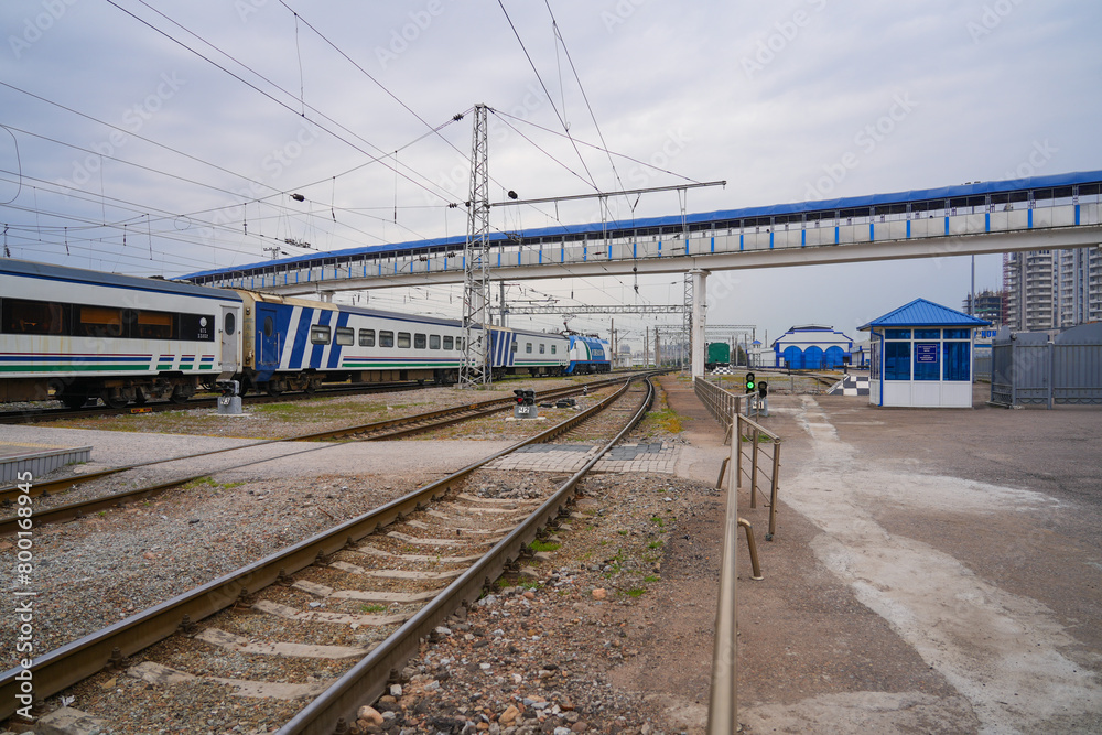 Obraz premium Pedestrian footbridge passing over the railway tracks at Tashkent North Station in Uzbekistan, Central Asia