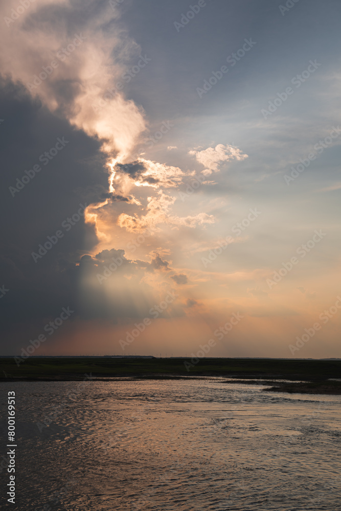 The light of Jesus burning the clouds in the evening beside the Nen River