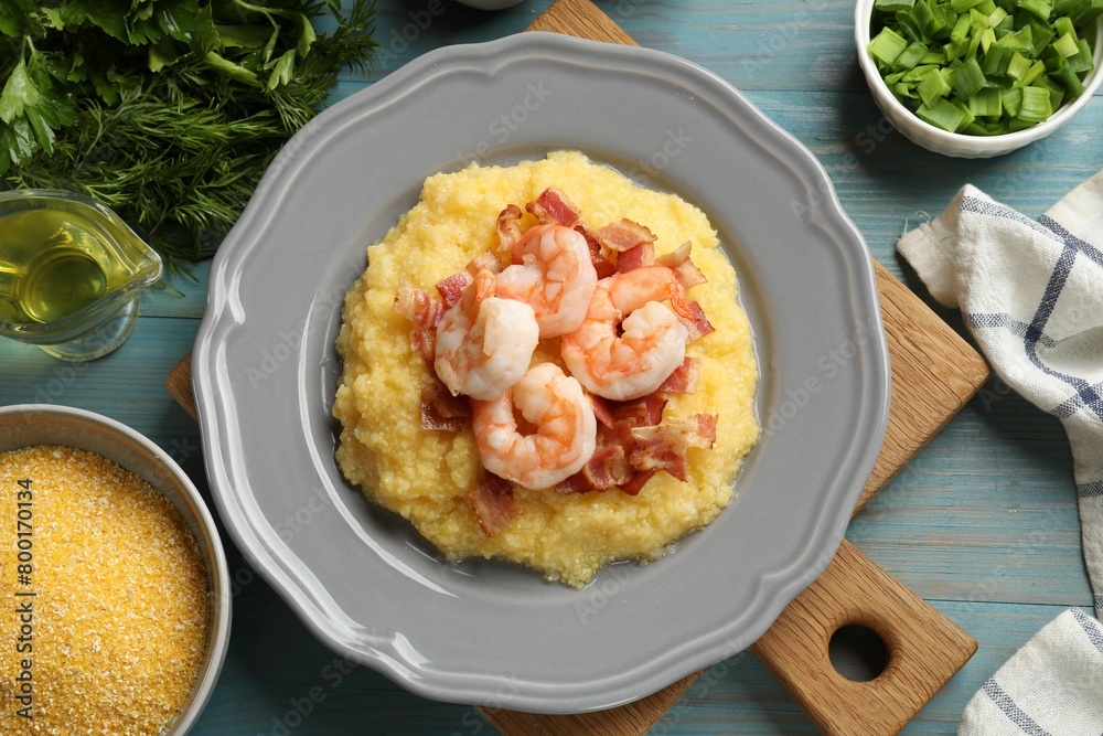 Plate with fresh tasty shrimps, bacon, grits and green onion on light blue wooden table, flat lay Plate with fresh tasty shrimps, bacon, grits and green onion on light blue wooden table, flat lay