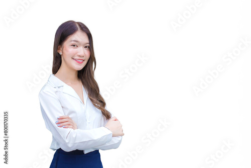 Young Asian businesswoman wearing white shirt and standing confidently with her arms crossed smile she working the office while isolated white background.