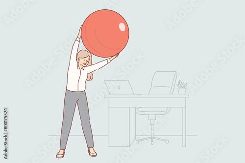 Woman office manager does gymnastics at workplace, uses pilates ball to stretch spine