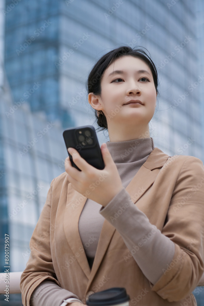 Young Professional Using Smartphone in Urban Setting Young Professional Using Smartphone in Urban Setting