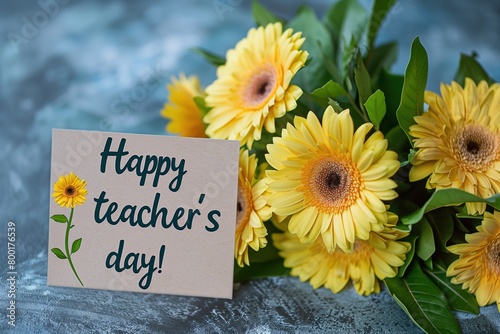 A card with the inscription "Happy teacher's day!" and yellow gerbera flowers on it