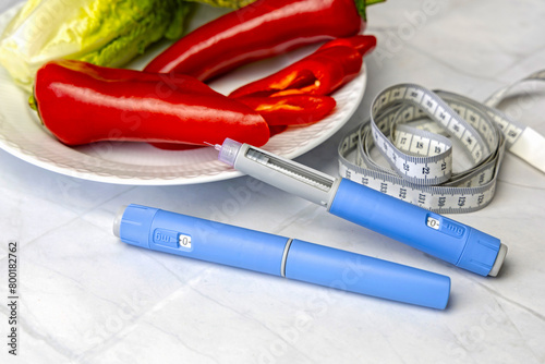Original Danish Ozempic Insulin injection pen for diabetics and plate with vegetables. photo