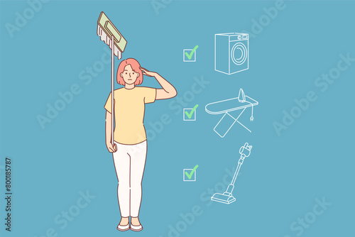 Woman housewife completed all housework stands in soldier pose with mop in hands