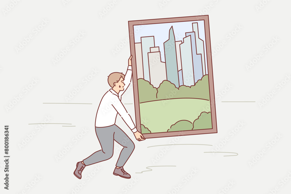 Man carries painting of green metropolis through desert, trying to achieve goal of building city Man carries painting of green metropolis through desert, trying to achieve goal of building city