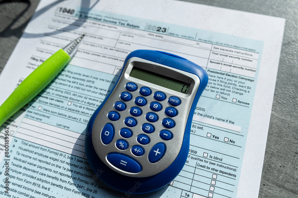 1040 TAX form blank on a calculator. Individual Income Tax Return 1040 TAX form blank on a calculator. Individual Income Tax Return