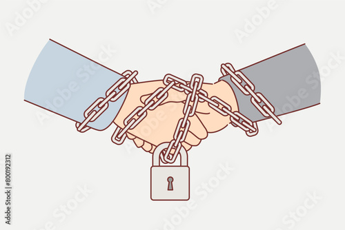 Business handshake between two partners with hands chained and locked, as sign of guaranteeing