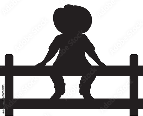 Young Cowboy on Fence