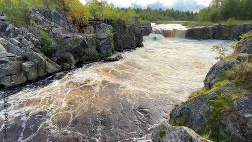 Voytsky padun waterfall in autumn. The famous powerful and wide Karelian waterfall Voytsky Padun is surrounded by rocks and greenery. Cascading waterfall on the river. Karelia, Russia 4K photo