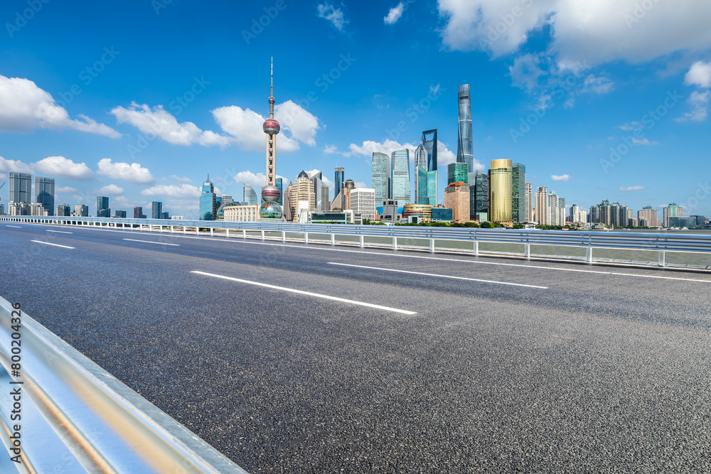 Asphalt highway road with modern city commercial buildings scenery in Shanghai. Famous city landmarks in China. Asphalt highway road with modern city commercial buildings scenery in Shanghai. Famous city landmarks in China.