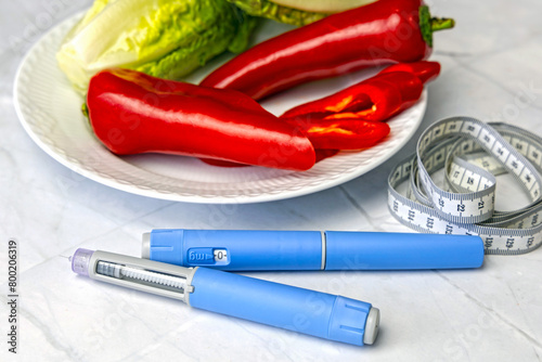 Original Danish Ozempic Insulin injection pen for diabetics and plate with vegetables. photo