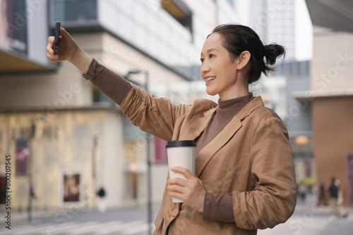 Urban Woman Enjoying Coffee and Taking Selfie