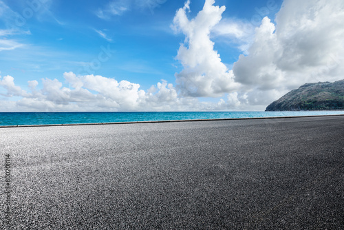 Asphalt road and blue sea with island nature landscape on a sunny day