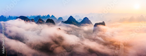 Sea of clouds around mountain peaks at sunrise. Famous karst mountain natural landscape in Guilin, China.