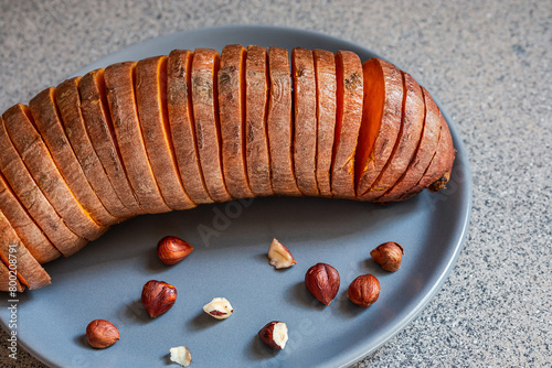 Baked hasselback sweet potatoes with hazelnuts