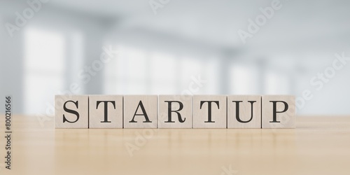 Business concept text STARTUP cubes on office blured background