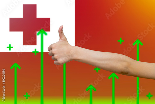 Tonga flag with green up arrows,  finger thumbs up front of Tonga flag, increasing values 