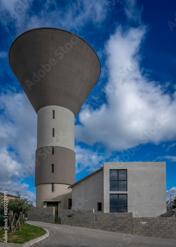 Lecques, France - 04 15 2024: View of an old water tower converted into a residential house in the south of France. photo