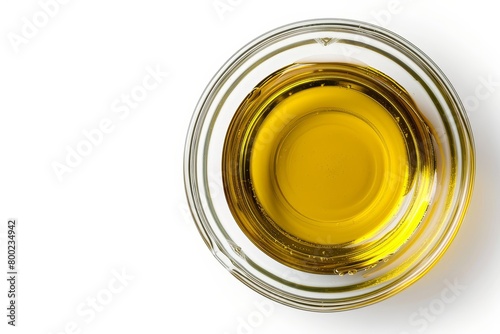 Glass bowl with olive or cooking oil on white background Top view Flat lay