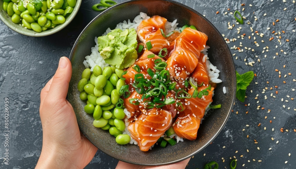Healthy recipe concept with salmon poke bowl rice edamame and guacamole Healthy recipe concept with salmon poke bowl rice edamame and guacamole