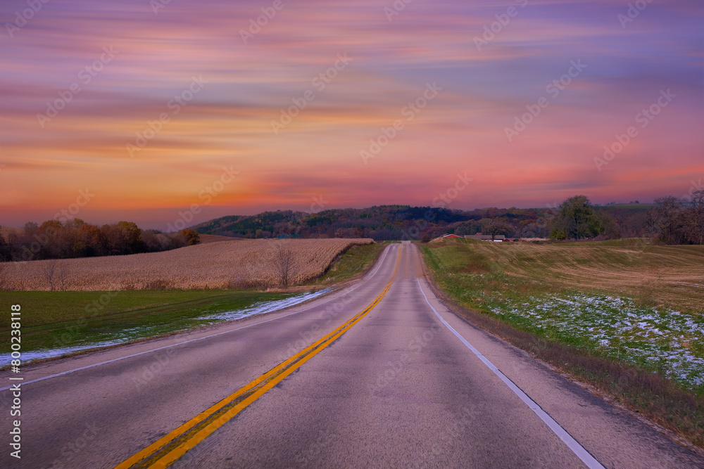 Empty asphalt road in rural landscape at sunset , USA 
