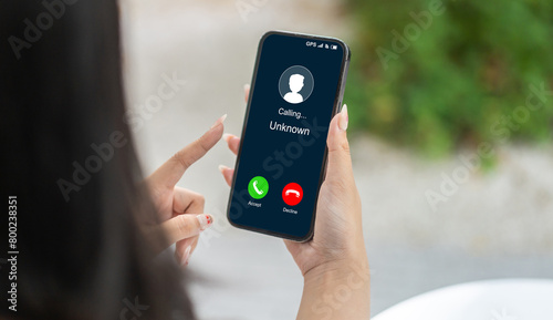 Obraz na płótnie Human use smartphone with incoming call from unknown number, spam, prank caller,