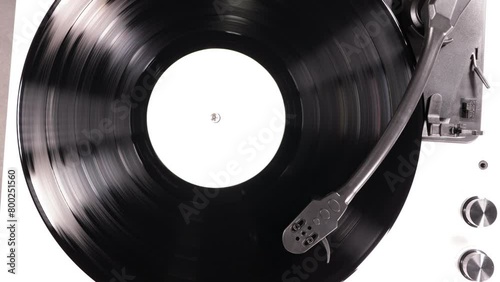 Vinyl retro record on DJ turntable record player. Black vinyl background with white screen in center. 